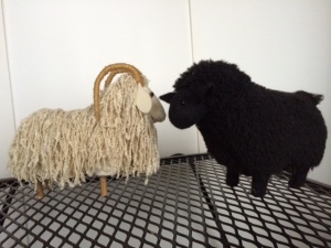 Soft sculptures - white ram facing black sheep